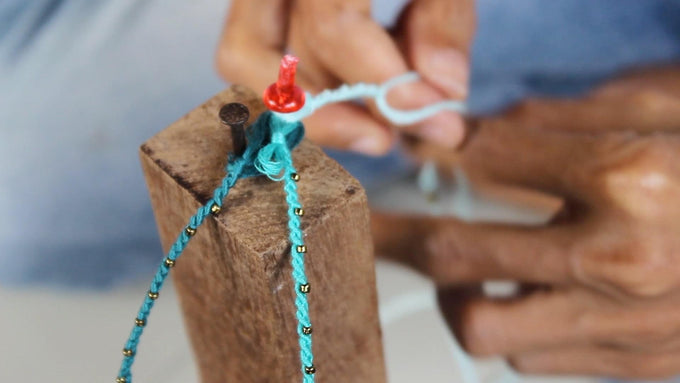 making bracelet in bali